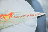 Vintage felt banner with pointed end, showing faded red Kentucky Horse Park text.