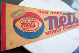 Vintage New York Nets pennant with red felt binding, faded gold crown, and red and blue logo.