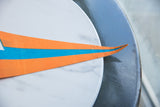 Pointed tip of the vintage orange felt pennant with blue stripe, showing light creasing.