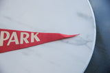 Visible texture of the red felt and lettering on the pointed pennant tip.