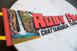 Retro illustration of the waterfall and castle on the vintage Ruby Falls felt pennant.