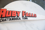 Bold red block lettering with black shadow on a vintage white felt pennant.