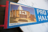 Close-up of vintage Pro Football Hall of Fame felt pennant's red binding and American flag.