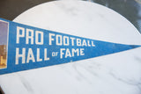 Blue felt Pro Football Hall of Fame pennant with white lettering and texture.