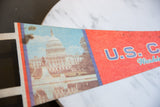 Close-up of vintage felt pennant showing US Capitol photo, colored border stripes, and subtle marks.
