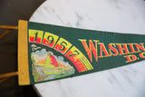 Vibrant graphic of The Capitol building and 1957 date on green felt.