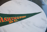 Textured green felt and vintage lettering on the pointed tip of the DC pennant.