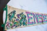 Emerald green felt binding and beige fabric with colorful fish motif, showing small pinholes.