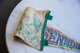 Felt texture and faded purple, teal lettering on rolled vintage Ensenada pennant.