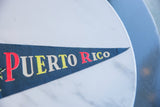 Vintage Puerto Rico felt pennant showing textured dark blue and colorful 'Puerto Rico' letters.