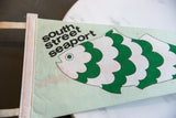 Vintage South Street Seaport felt pennant, green fish art, black text, minor discoloration.