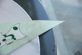Vintage South Street felt pennant's light green tip showing texture and minor staining.