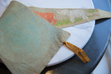 Folded vintage felt pennant showing its light blue-green texture, stitched edge, and brown tie.