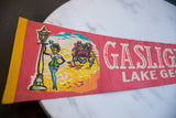 Vintage Gaslight Village felt flag illustration: woman by gaslight lamp and yellow binding.