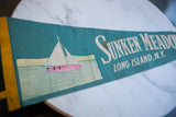 Close-up of vintage teal felt pennant with 'Sunken Meadow Long Island N.Y.' white text.