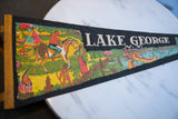 Vintage Lake George felt pennant with indigenous life graphics and visible creasing.