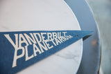 Visible pinholes on the pointed tip of the Vanderbilt Planetarium blue felt flag.