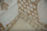 Detail of a Vintage Kars rug's short ivory and camel pile and hand-knotted reverse.