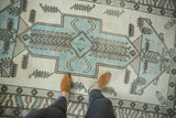 Distressed Oushak rug, powder blue stylized medallion with finned plant motifs.