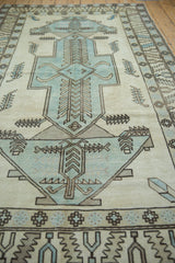 Geometric powder blue and ivory Oushak rug with serrated leaves, showing distressed texture.