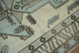 Distressed vintage Oushak rug, ivory and powder blue field, with serrated leaves and floral elements.