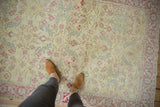 Softly distressed texture and spiraling floral pattern on a vintage lime green Sparta rug.