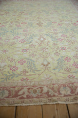 Low perspective of a distressed Sparta rug's floral pile in lime green, pink, and blue.