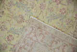 Hand-knotted foundation and distressed floral pile of a vintage Sparta rug.