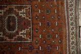 Afghani Belouch rug with rust field, geometric motifs, and striped side selvage.