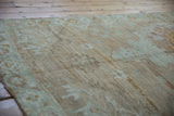 Vintage distressed Oushak rug runner with mocha, ivory, mint green geometric buds, even wear, and subtle abrashes.