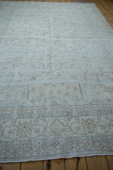 Distressed vintage Sparta carpet corner with faded floral vinery, powder blue accents, and even pile wear showing foundation.