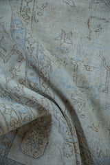Distressed vintage Sparta carpet pile, revealing even wear, vinery patterns, and pale blue.