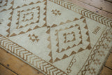 Ivory and coffee brown geometric pattern, arrowed border detail, on distressed Kars runner.