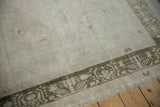 Low pile texture and time-softened sage green geometric border on a vintage Oushak carpet.