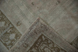 Folded corner of the vintage Oushak showing its short pile and hand-knotted foundation.