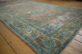 Worn dusty peach field and powder blue floral border on a distressed vintage Persian Lilihan carpet.