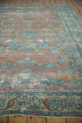 Distressed Lilihan carpet showing worn pile texture, dusty peach, and powder blue floral motifs.