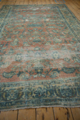 Vintage Distressed Lilihan carpet detail, showing faded peach and blue floral motifs with foundation wear.