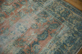 Distressed Lilihan carpet detail: worn floral pattern, dusty peach and blue, exposed foundation.