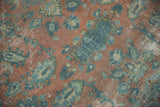 Distressed Lilihan carpet detail: faded peach, blue floral patterns, areas of visible foundation.
