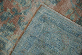 Hand-knotted foundation and distressed blue, peach pile of a Vintage Lilihan carpet.