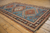 Vintage Caucasian rug's stepped medallion and geometric guls in indigo blue, madder red.