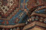 Vintage Caucasian rug, indigo blue field with geometric guls, madder red patterns, and pile texture.