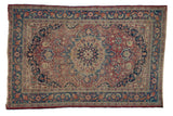 Vintage Persian Meshed rug with dusty red field, navy roundel medallion, boteh leaves, and blue floral borders, 4'1