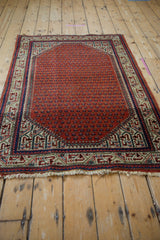 Vintage Mir Sarouk rug's Serbend boteh border with brick red field and tattered fringe.