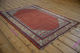 Vintage Mir Sarouk rug corner with Serbend boteh border, boteh field, and frayed ends.