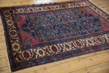 Perspective view of a vintage Lilihan rug, with its ruby spandrels framing a rich indigo Herati field.