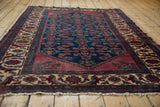 Low perspective view of the vintage Lilihan rug, highlighting the textured wool pile and ivory border.