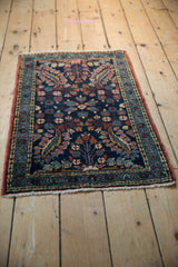 Vintage Dargezine rug corner with intricate floral motifs, deep blue field, and visible fringe.