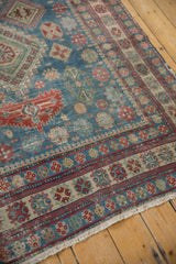 Vintage Distressed Caucasian rug border and fringe with geometric patterns in blue, red, ivory.